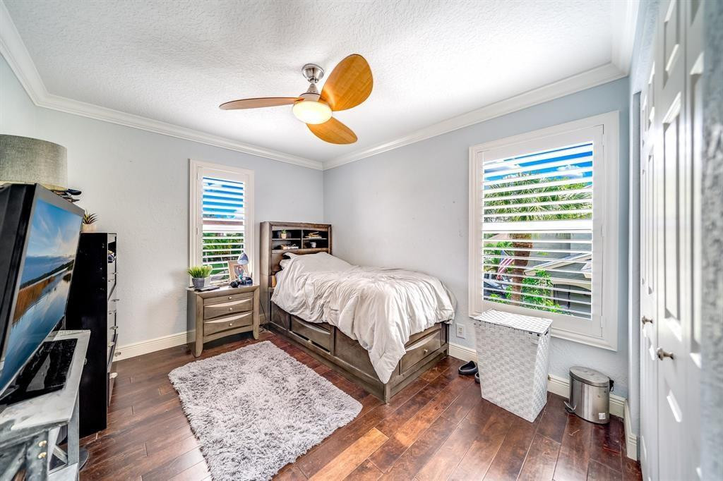 12036 Quilting Lane Boca Raton, FL 33428 - Photo 18 of 25 a bedroom with a bed and a large window