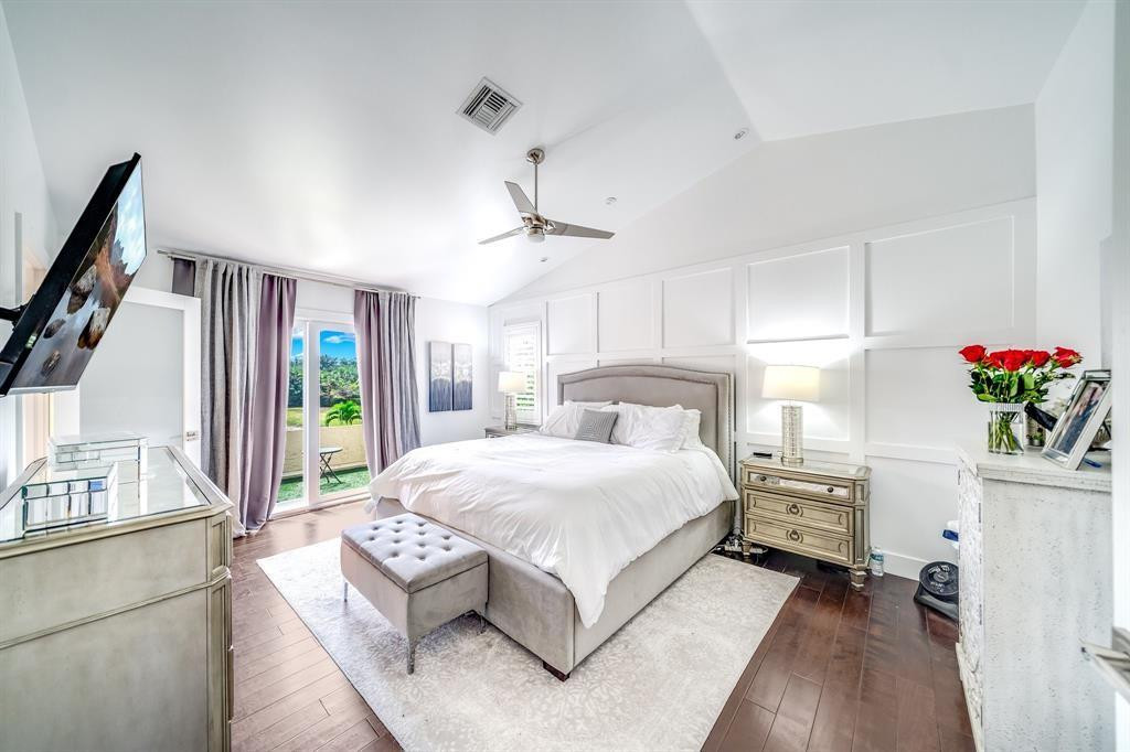 12036 Quilting Lane Boca Raton, FL 33428 - Photo 19 of 25 a bedroom with a large bed and a chandelier