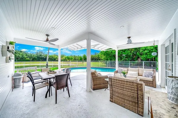 a view of a patio with a table chairs and backyard