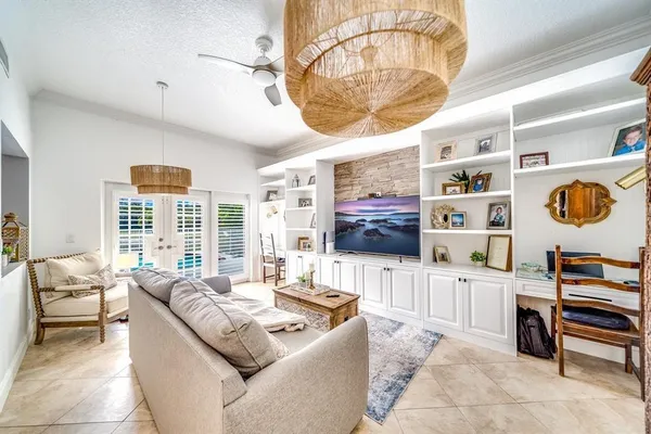 a living room with furniture and a chandelier