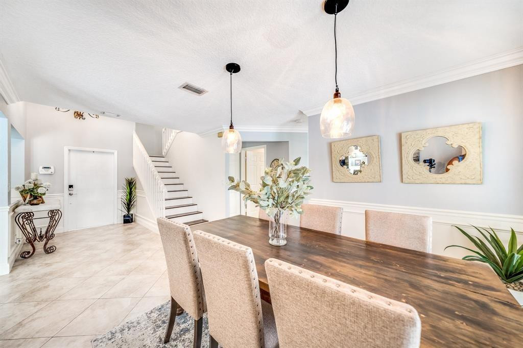 12036 Quilting Lane Boca Raton, FL 33428 - Photo 6 of 25 a view of a dining room and a livingroom with furniture wooden floor a chandelier