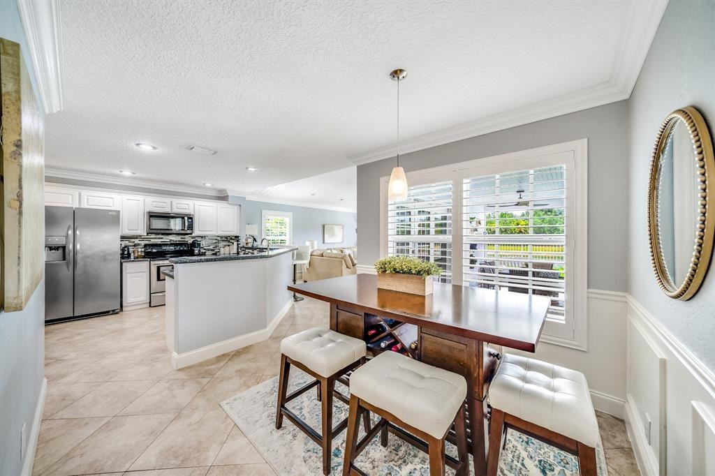 12036 Quilting Lane Boca Raton, FL 33428 - Photo 8 of 25 a kitchen with a refrigerator and a table