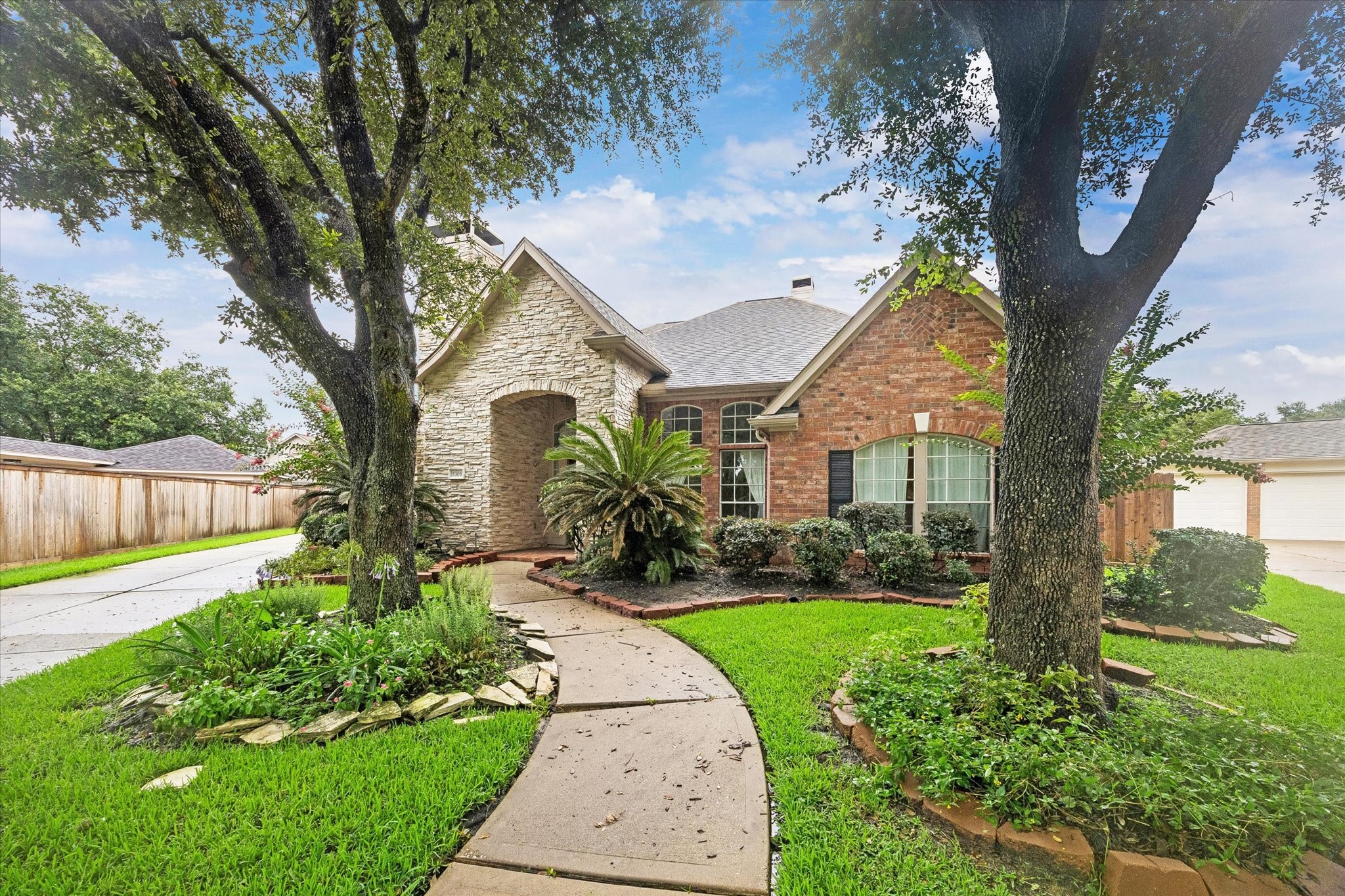 5306 Summerland Ridge Court Houston, TX 77041 - Photo 1 of 33 a front view of a house with garden