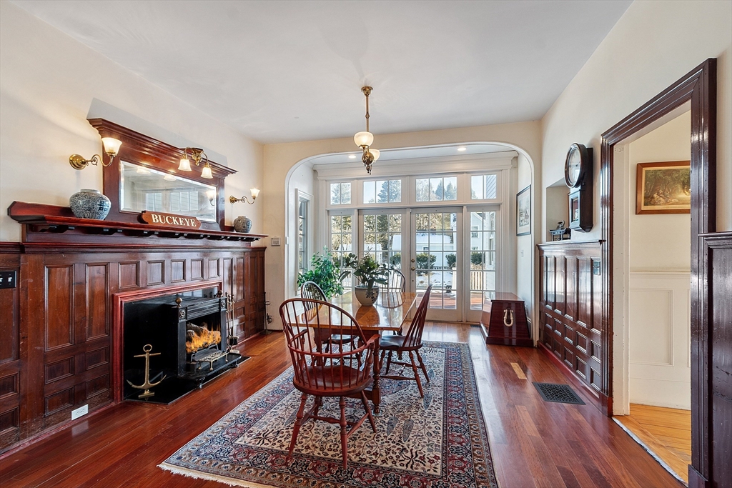 25 Fairhaven Road Concord, MA 01742 - Photo 16 of 42 a dining room with furniture a fireplace and wooden floor