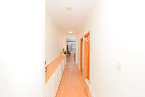a view of a hallway with wooden floor