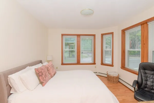 a spacious bedroom with a bed and a large window