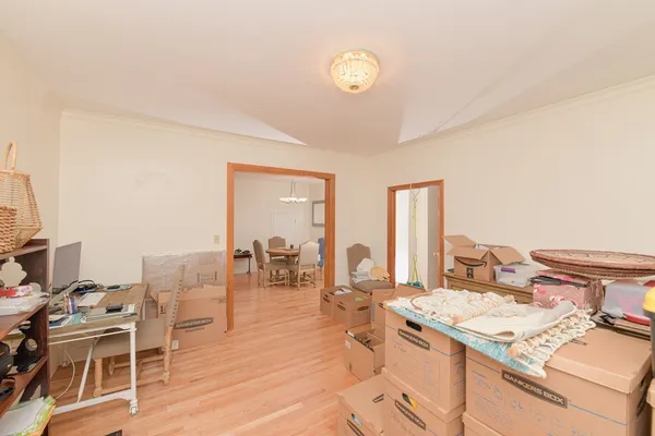 a living room with a sink and a stove with wooden floor