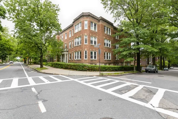 a view of a street with a building in the background