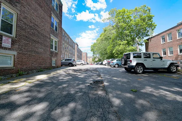 a cars parked in front of a brick building