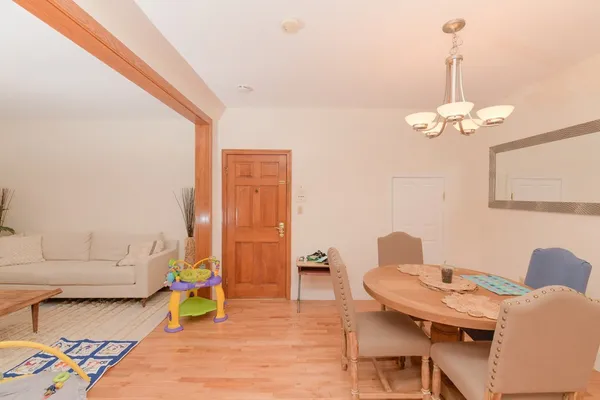 a dining room with furniture and a chandelier