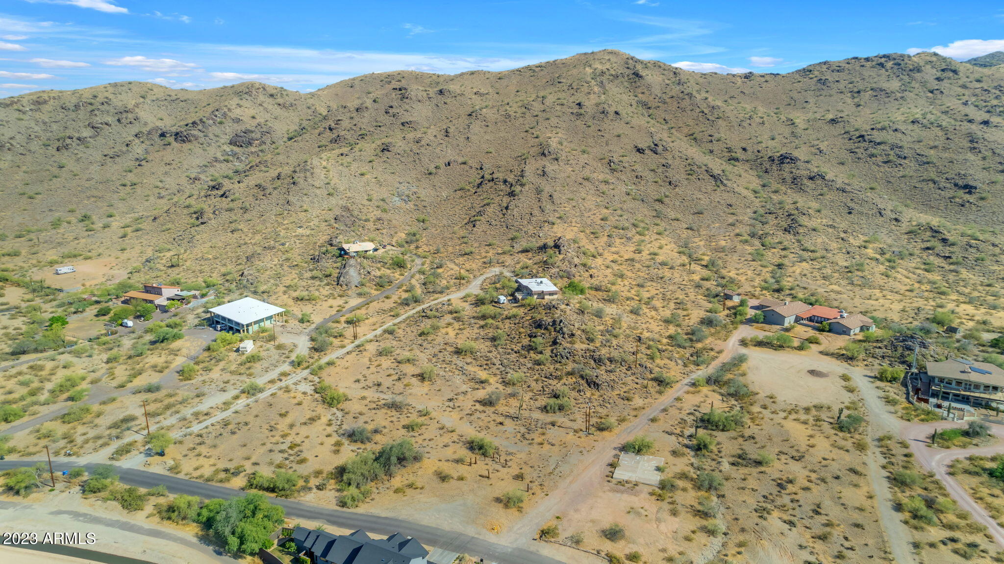 3425 East Highline Canal Road Phoenix, AZ 85042 - Photo 2 of 16 a view of a dry yard with mountains in the background