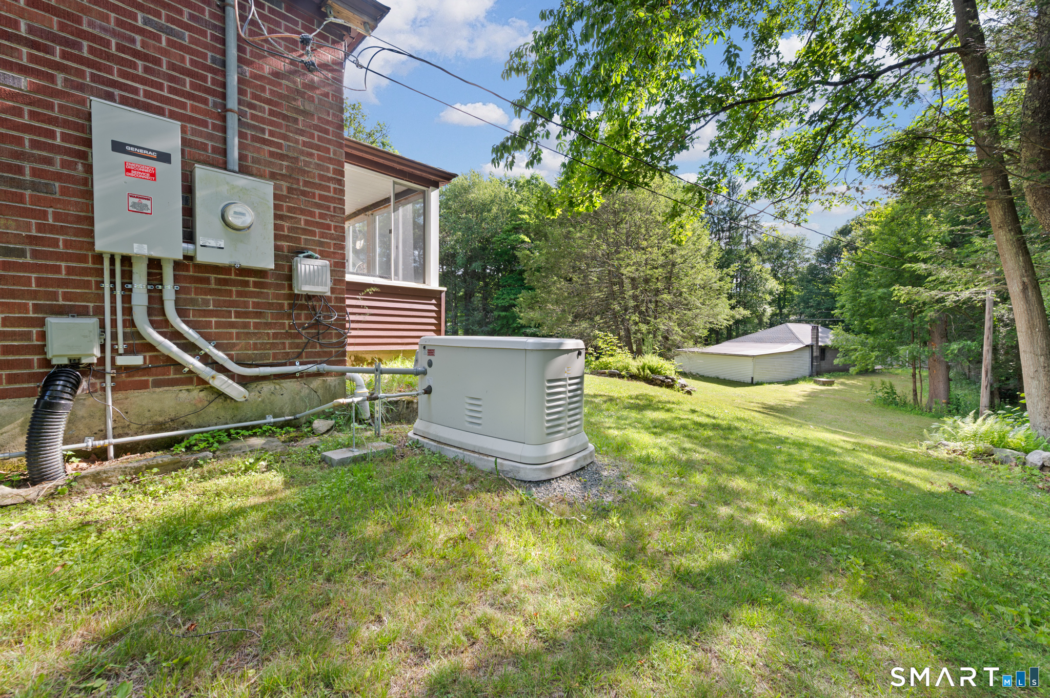 152 Ramstein Road New Hartford, CT 06057 - Photo 17 of 20 a view of a backyard with a table and chairs