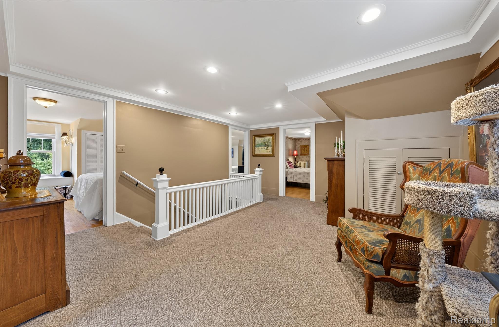 3841 Covert Road Waterford, MI 48328 - Photo 35 of 87 Carpeted landing featuring white spindle railing, recessed lighting, and crown molding