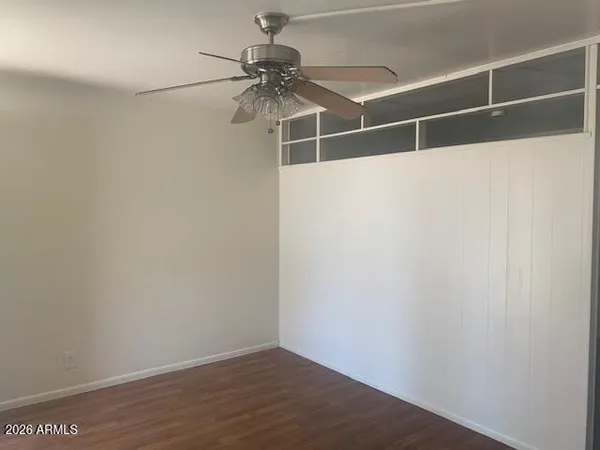 a view of a room with wooden floor