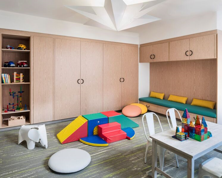 44-28 Purves Street, Unit 19B Queens, NY 11101 - Photo 9 of 19 a living room with lots of furniture and wooden floor