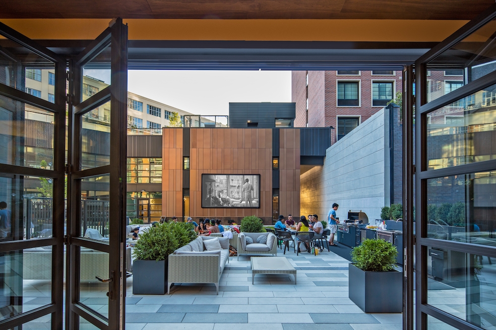 44-28 Purves Street, Unit 19B Queens, NY 11101 - Photo 10 of 19 a view of a patio with couches and potted plants