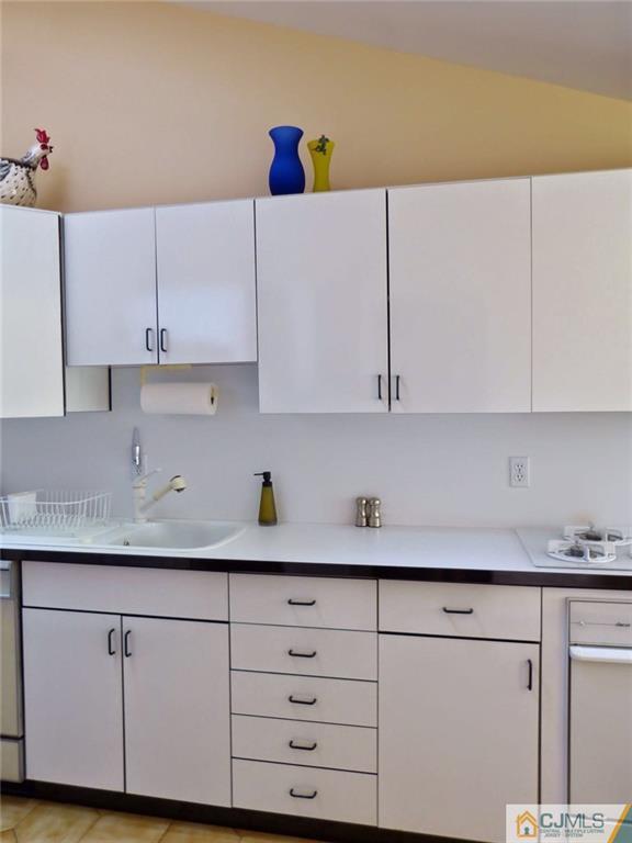 7 Gramercy Road Old Bridge, NJ 08857 - Photo 12 of 24 a kitchen with cabinets and white appliances