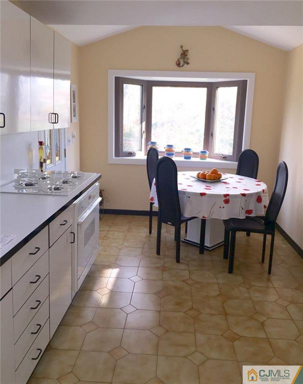 7 Gramercy Road Old Bridge, NJ 08857 - Photo 13 of 24 a dining room with a window and a table