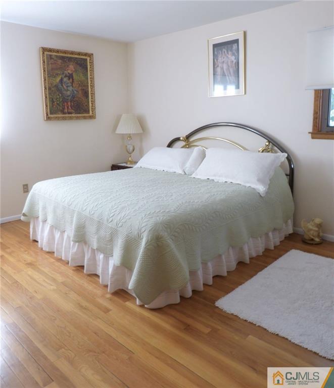 7 Gramercy Road Old Bridge, NJ 08857 - Photo 17 of 24 a bedroom with a bed and a painting on the wall
