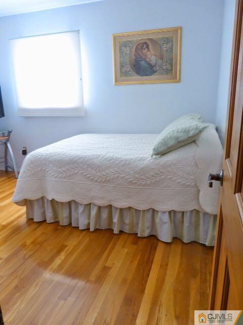 7 Gramercy Road Old Bridge, NJ 08857 - Photo 18 of 24 a spacious bedroom with a bed and wooden floor