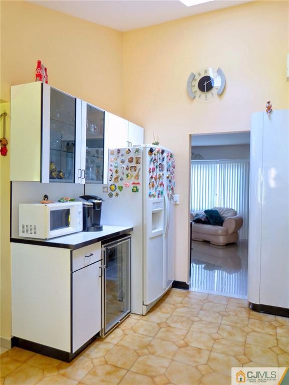 7 Gramercy Road Old Bridge, NJ 08857 - Photo 10 of 24 a kitchen with a sink and a refrigerator