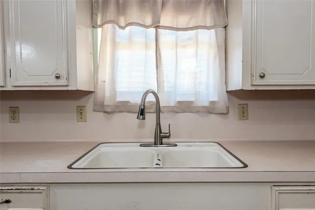 a kitchen with a sink and cabinets