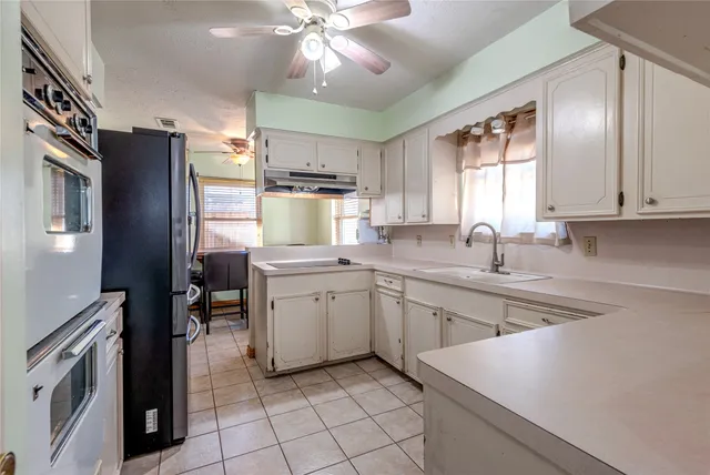 a kitchen with a sink microwave and refrigerator