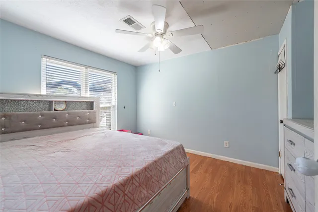 a bedroom with furniture and wooden floor
