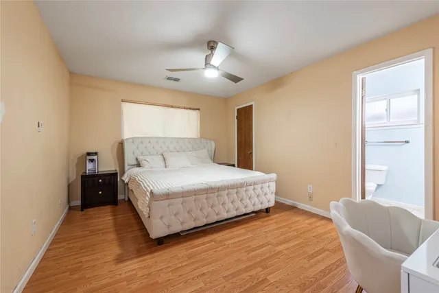 a bathroom with a sink a toilet and a window