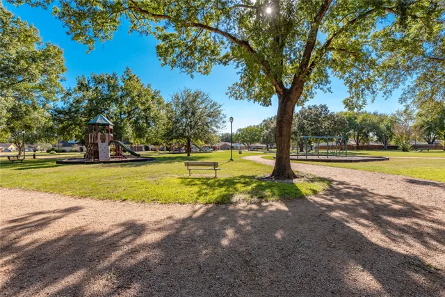 a view of a back yard with a wooden fence