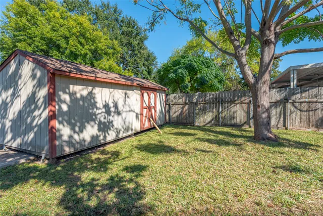 a view of a patio with table and chairs with wooden floor and fence