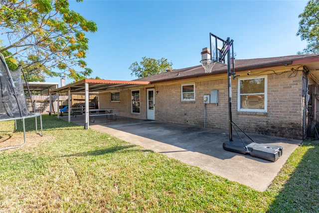 a view of a house with swimming pool next to a yard