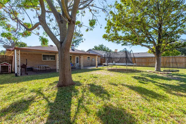 a view of a backyard with swimming pool
