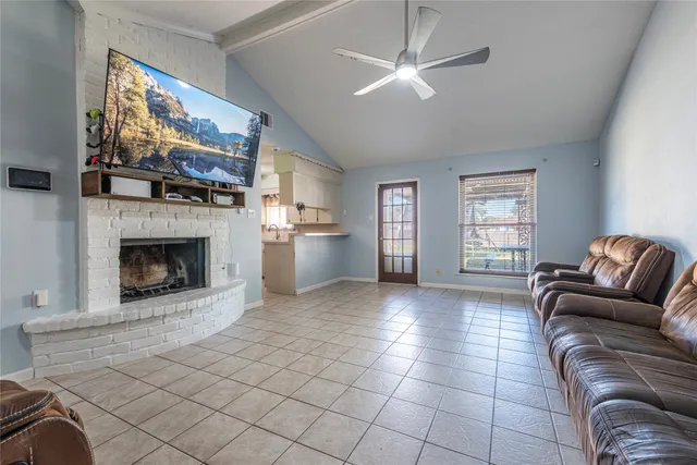 a living room with furniture a flat screen tv and a fireplace