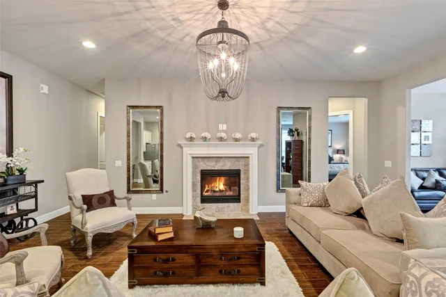 a living room with furniture a table and a large window