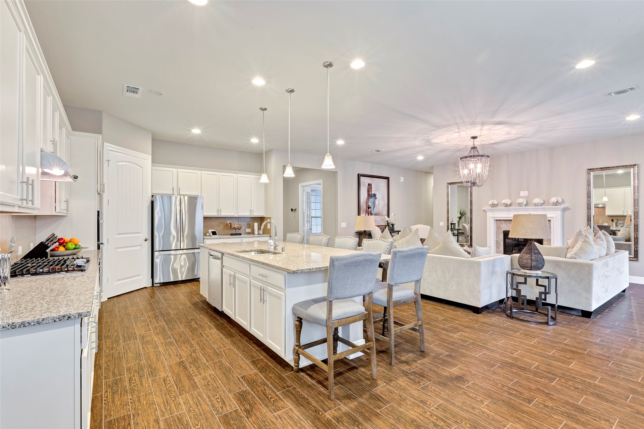 a large white kitchen with lots of counter space and furniture