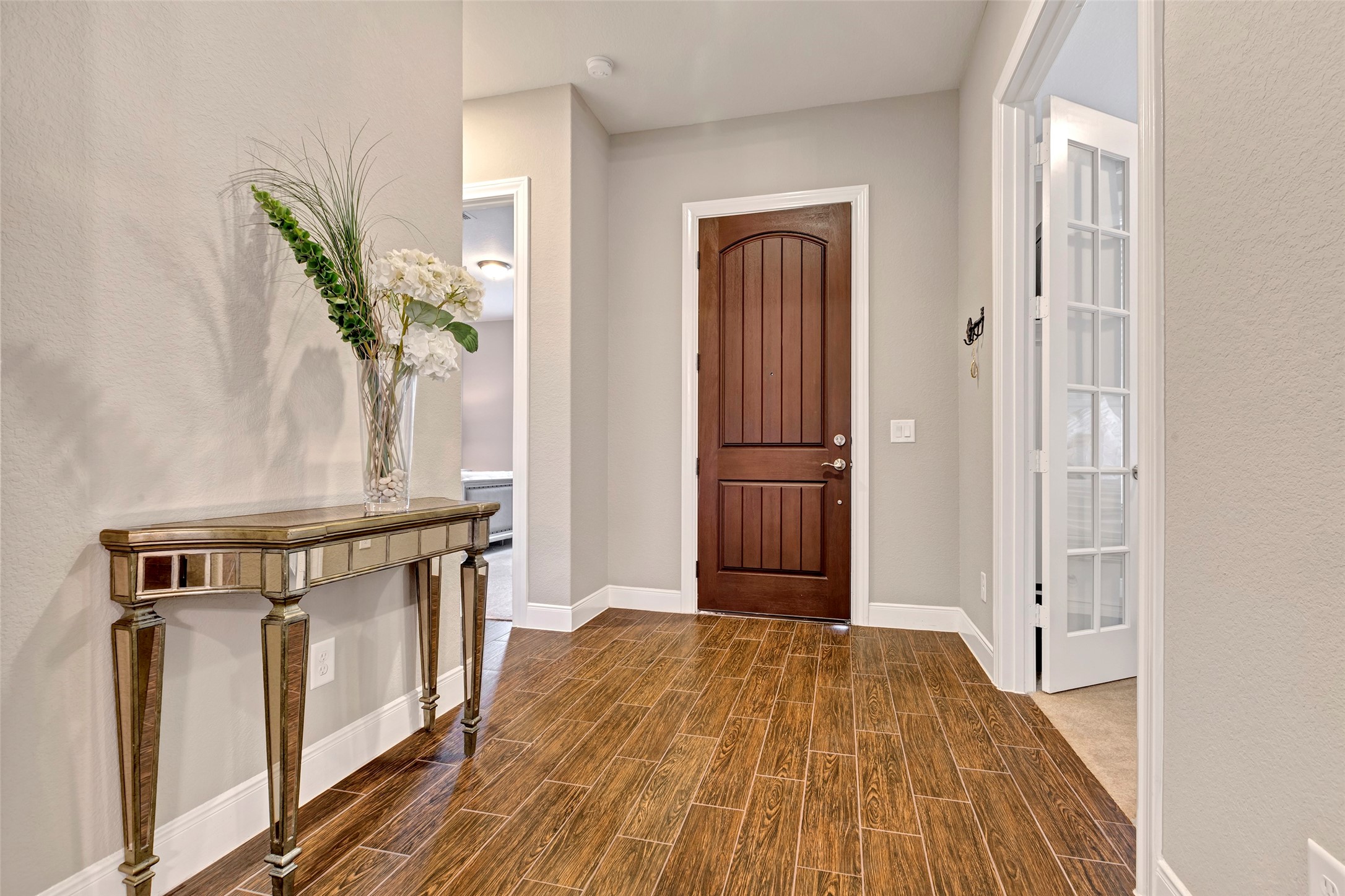 342 Kerry Bog Lane Spring, TX 77382 - Photo 3 of 39 a view of a hallway with wooden floor and staircase