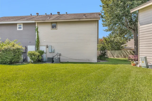 a view of a house with a yard and garage