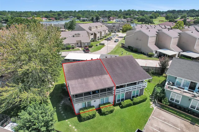 an aerial view of multiple houses with a yard