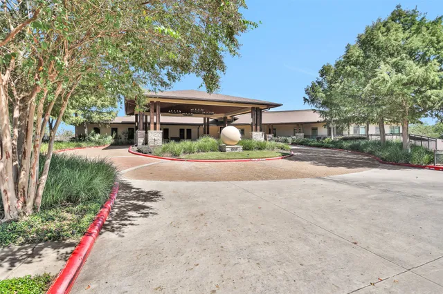 a front view of a house with a yard and a garage