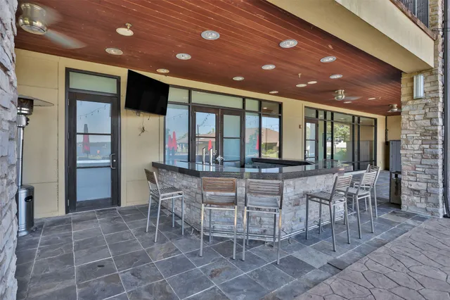 a dining hall with stainless steel appliances a dining table and chairs
