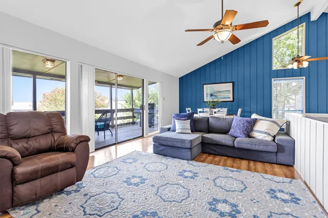 a living room with furniture wooden floor and a window