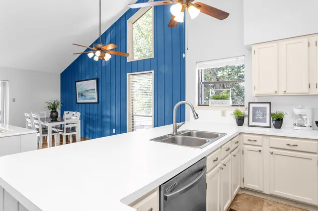 a kitchen with a sink cabinets and window