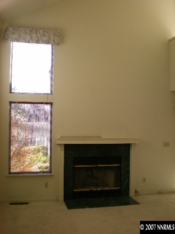2910 Alpine Creek Road Reno, NV 89519 - Photo 6 of 9 a living room with a fireplace and a window