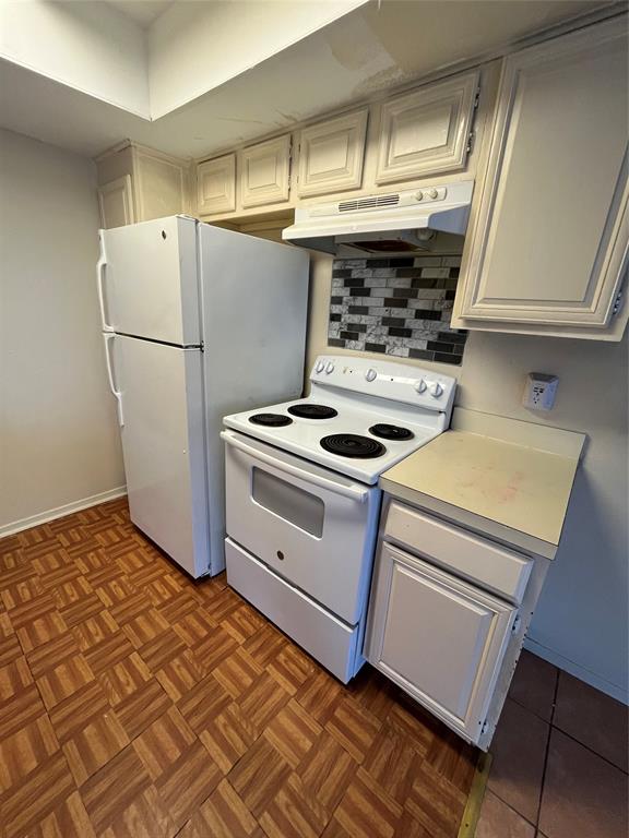 4460 Chaha Road, Unit 205 Garland, TX 75043 - Photo 8 of 27 a kitchen with a stove and a refrigerator