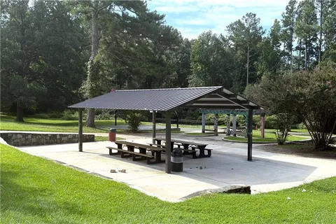 a view of a patio with table and chairs under an umbrella