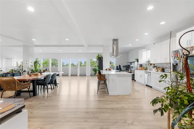 an open kitchen with white cabinets and stainless steel appliances