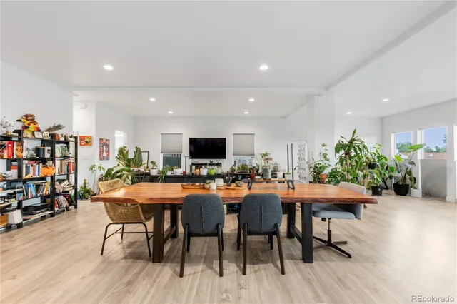a dining room filled with furniture and wooden floor