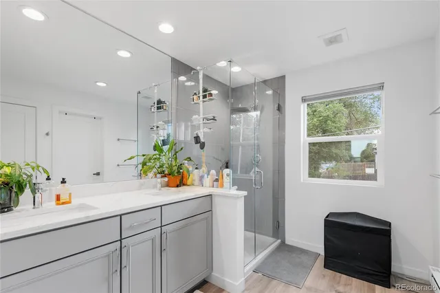 a bathroom with a shower sink and mirror