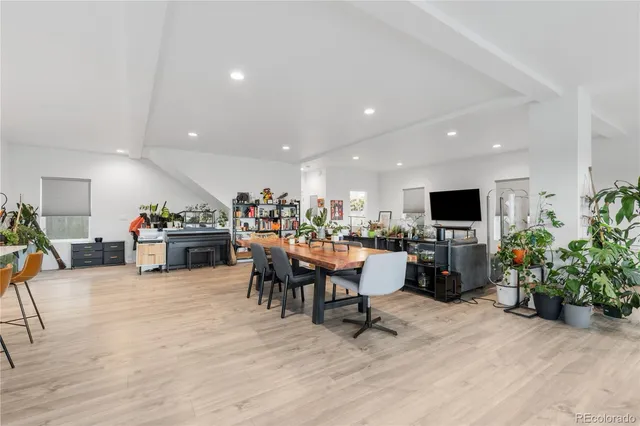 a view of a workspace with furniture window and wooden floor